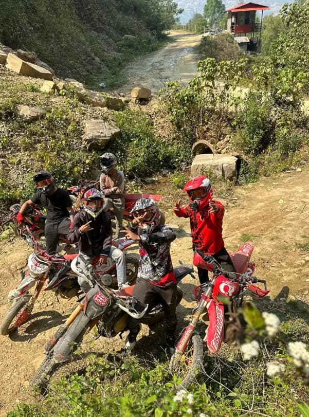 Group of riders with dirt bikes on a trail