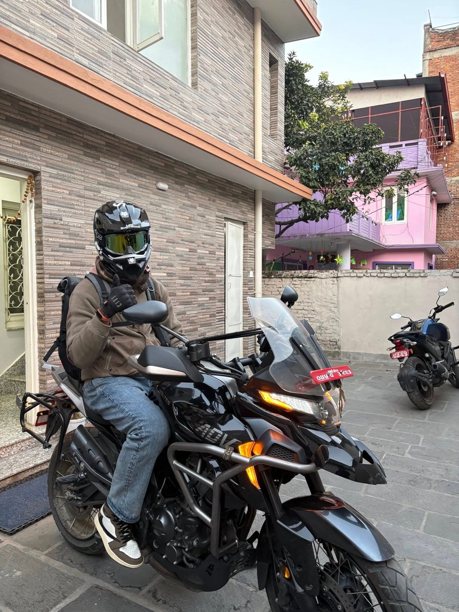 Helmeted rider in fog on an off-road motorcycle
